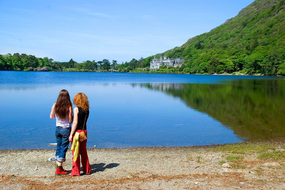 Two girls enjoying the view of Kylemore Abbey Across the Lake